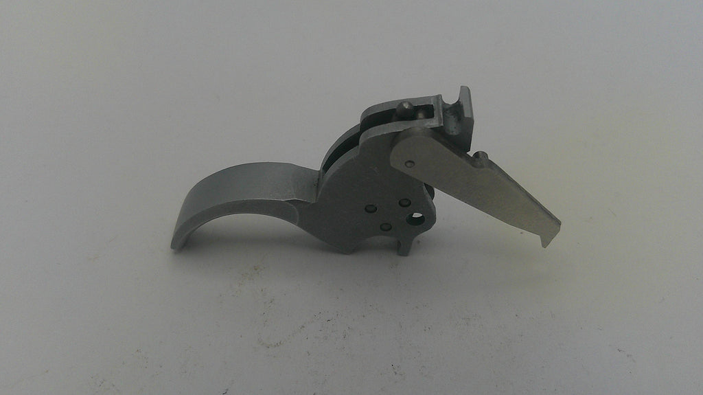 Metallic gun trigger on a white background