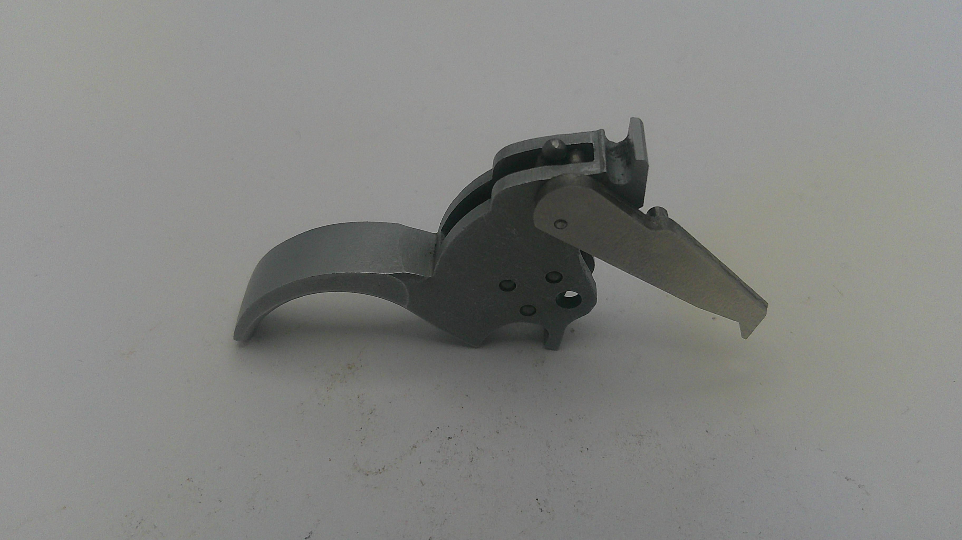 Metallic gun trigger on a white background
