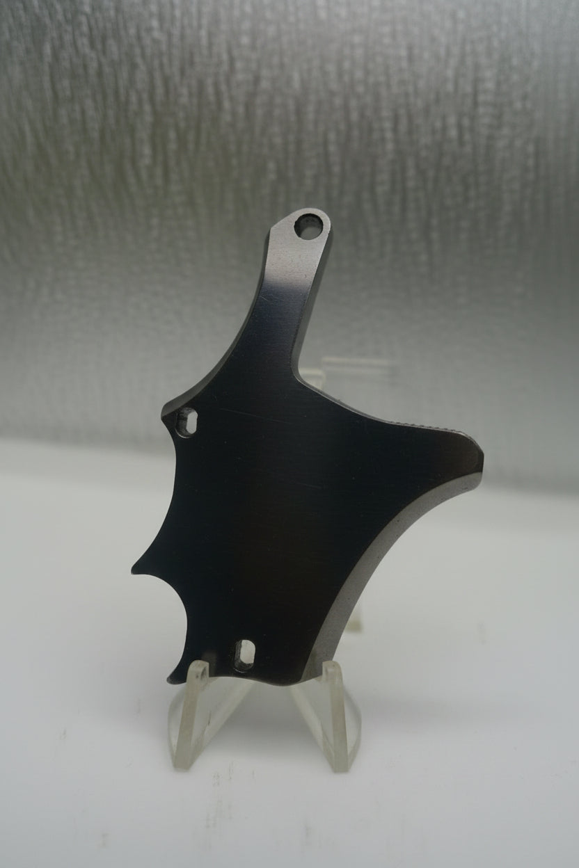 Black plastic component on a textured gray surface