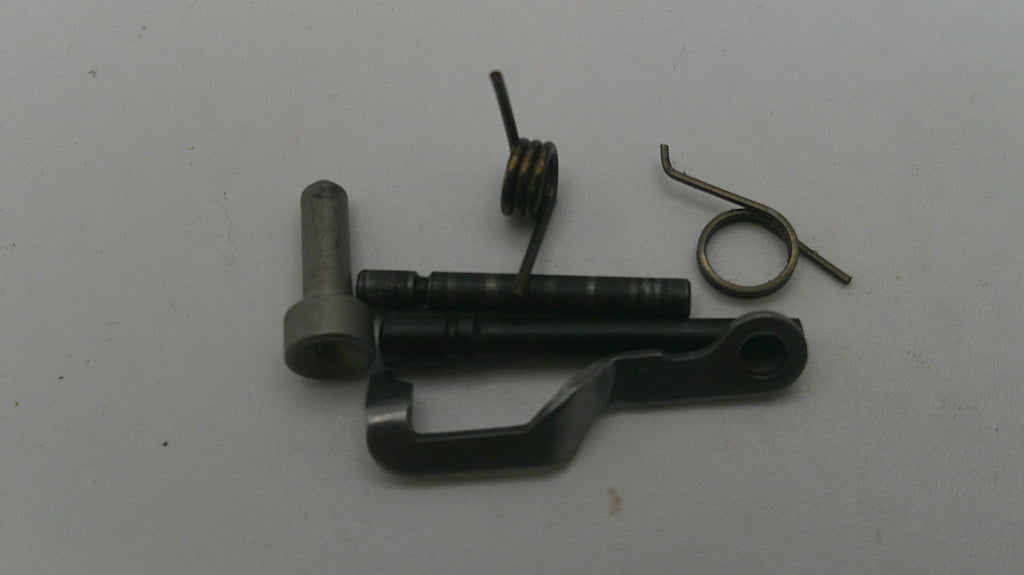 Mechanical parts including a metal rod, spring, and other components on a white background