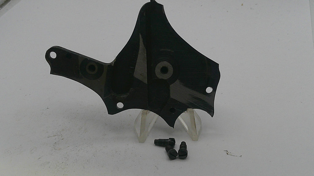 Black plastic car part with screws on a white background