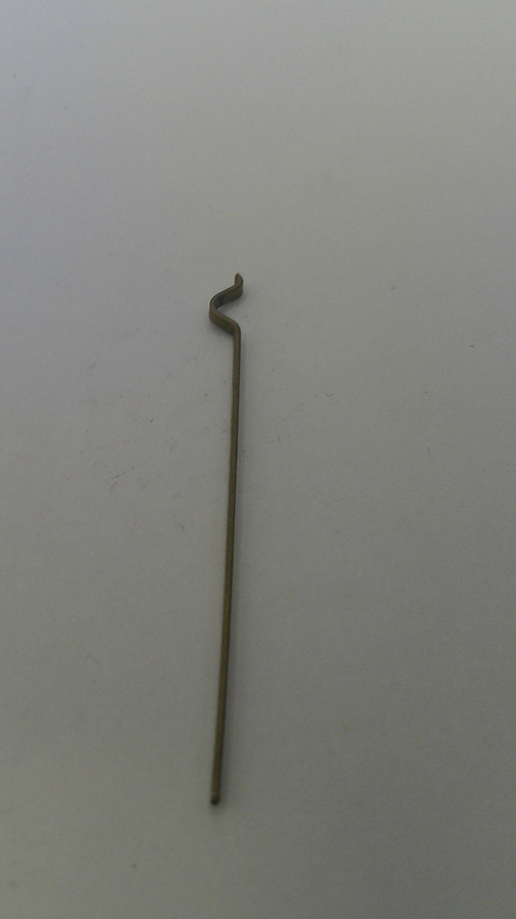 Metal rod with a curved end on a white background