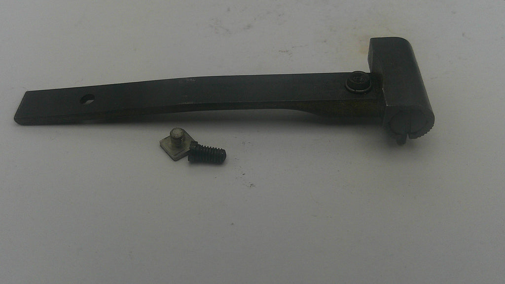 A black metal latch bracket with a small matching screw and washer, shown on a plain off-white surface.