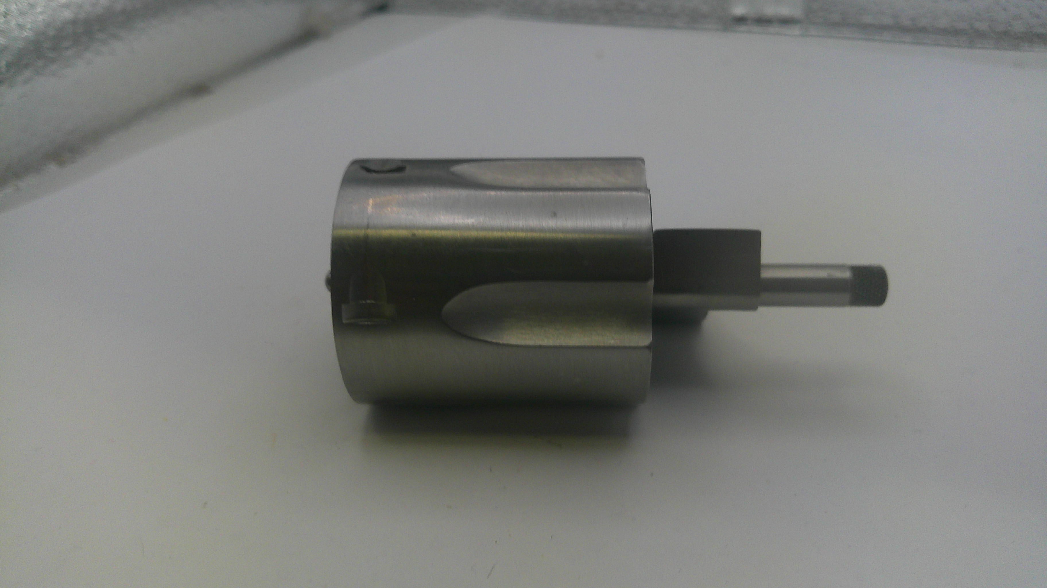 Metallic cylindrical object on a white surface