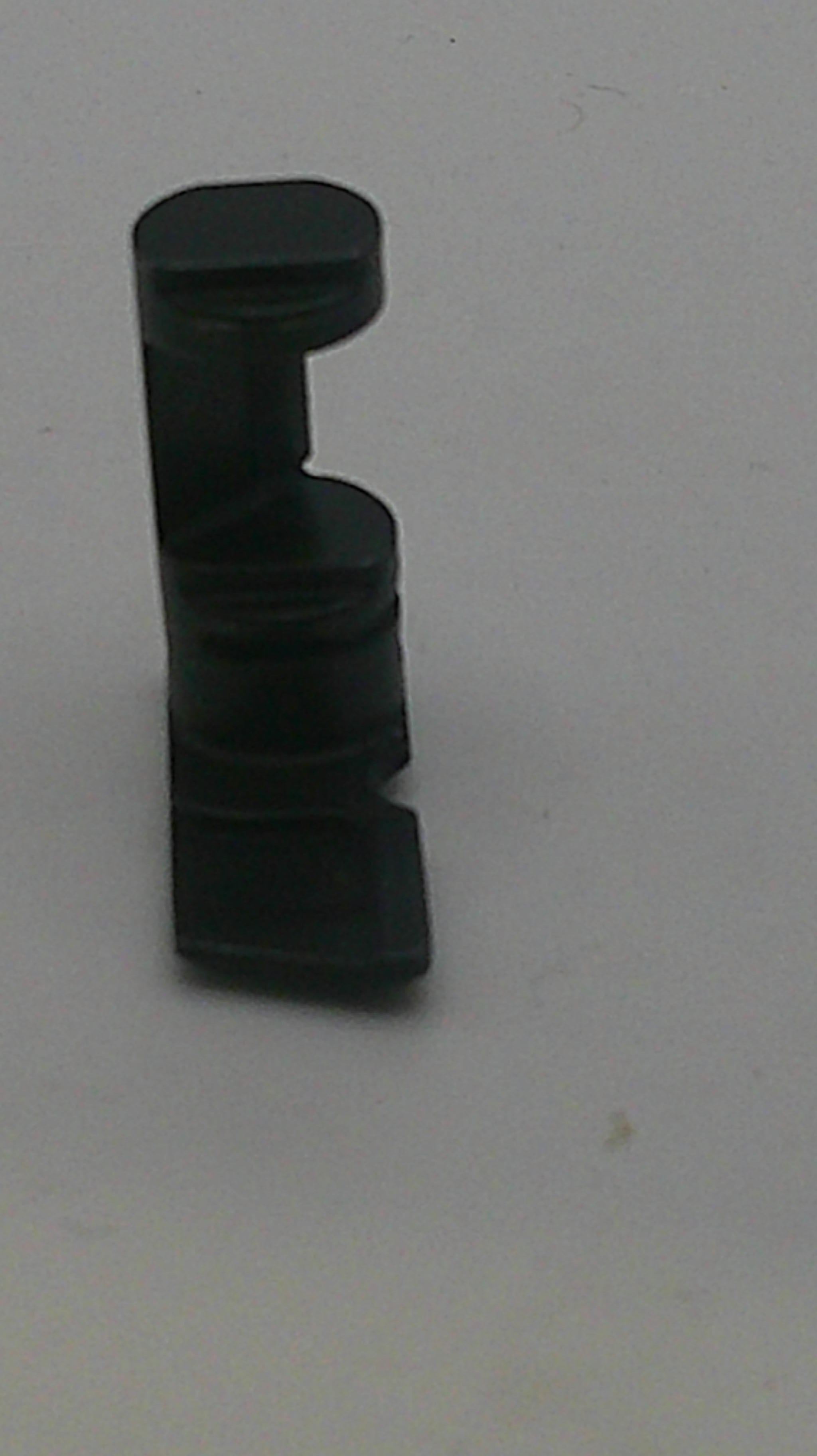 Black plastic component on a white background