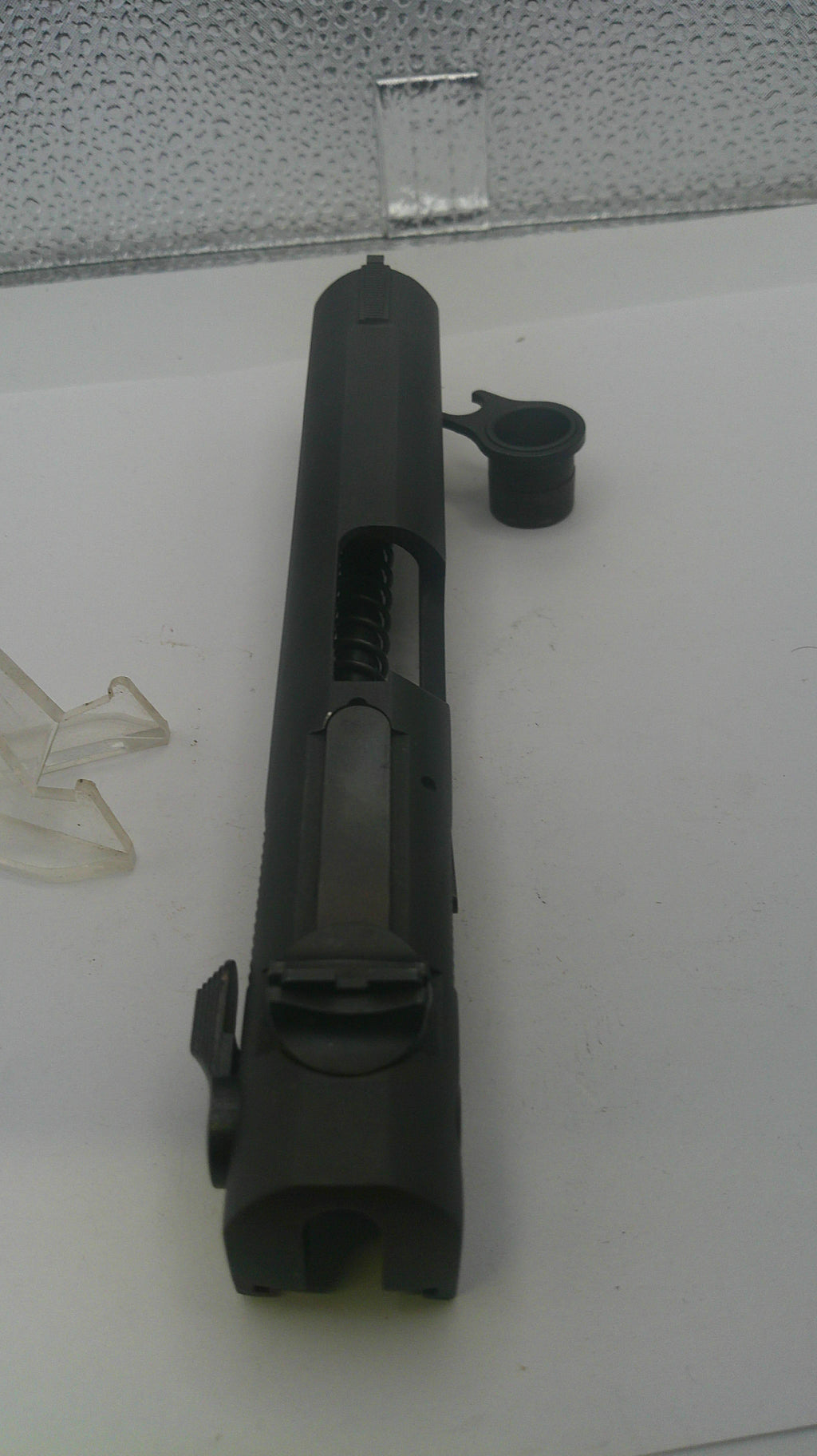 Black metal component on a white surface