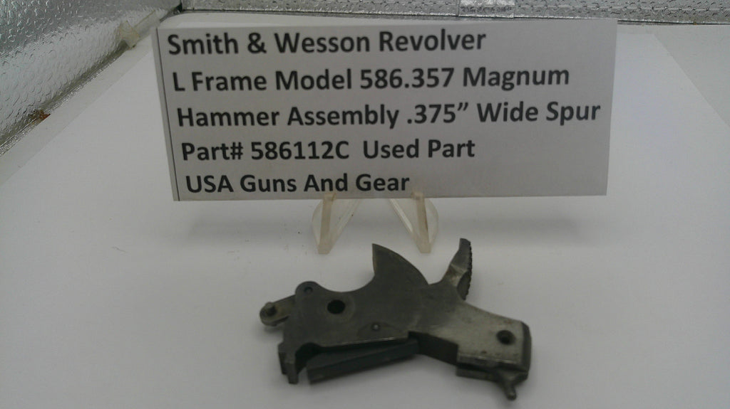Smith & Wesson revolver hammer assembly on a white background with a label.
