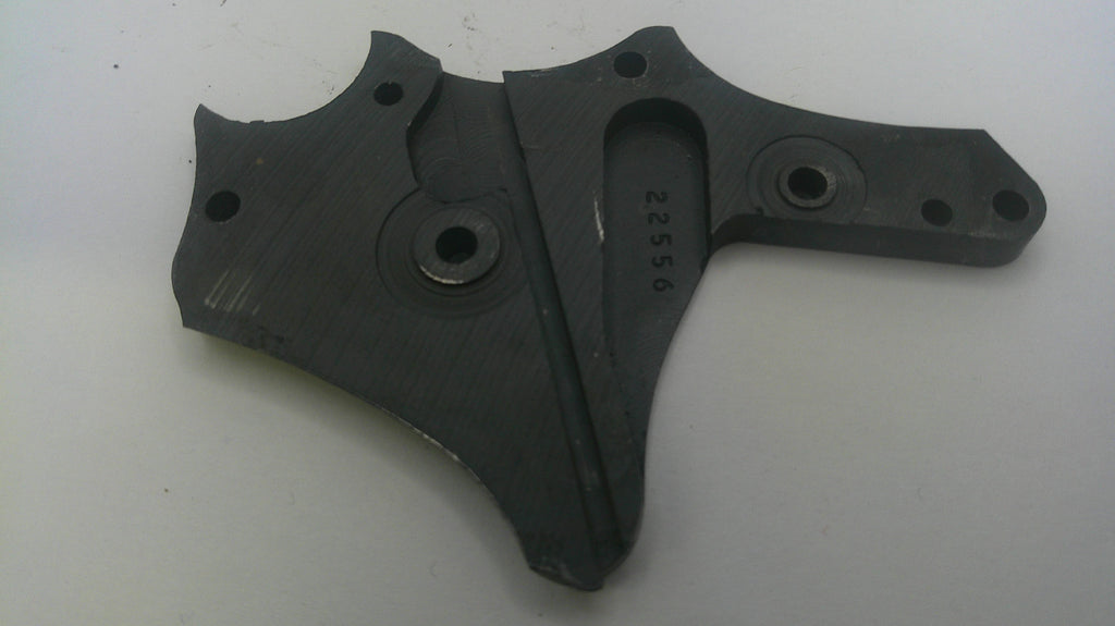 A dark gray cast metal mechanical part with pre-drilled mounting holes and stamped serial numbers, shown on a plain light background.