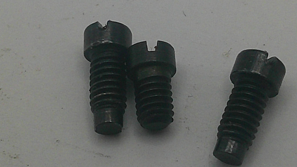 Three black metal slotted screws with threaded shafts, shown on a plain light gray surface.