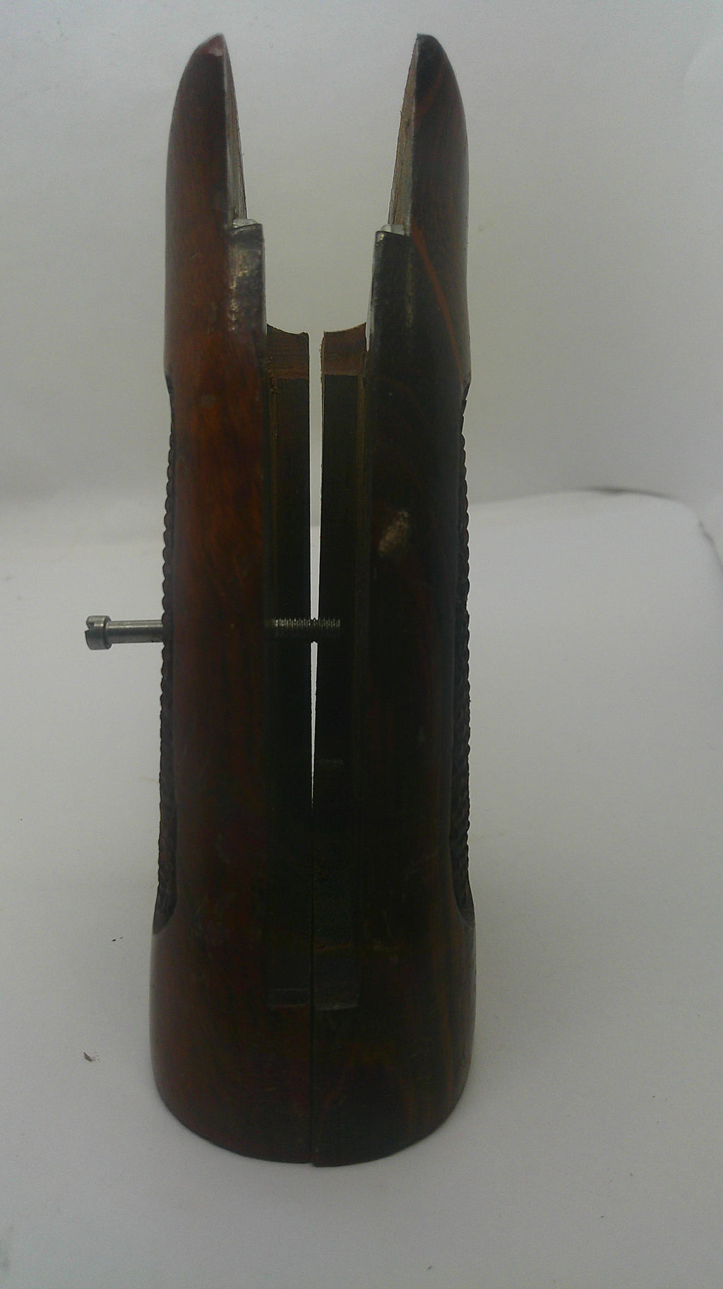 A dark brown wooden hand plane with a metal adjustment screw visible on top, photographed against a plain white background.