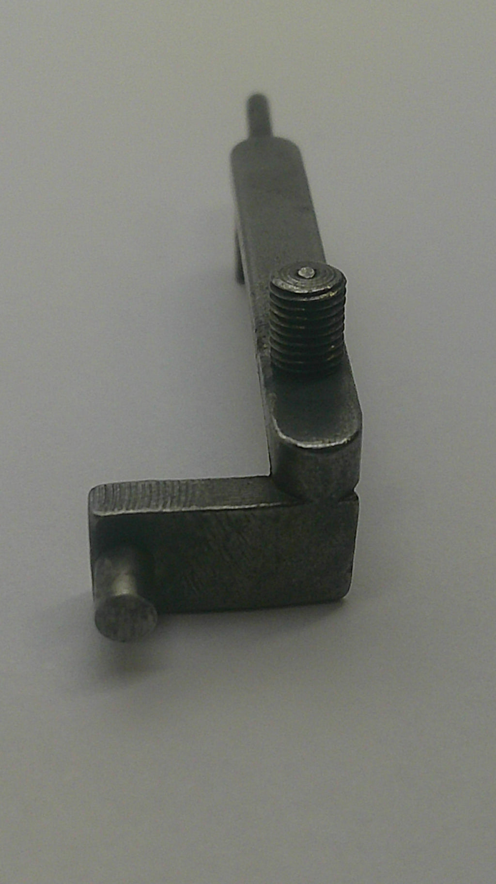 A small dark metal hardware piece with a threaded rod and a flat rectangular bracket, photographed against a plain light background.