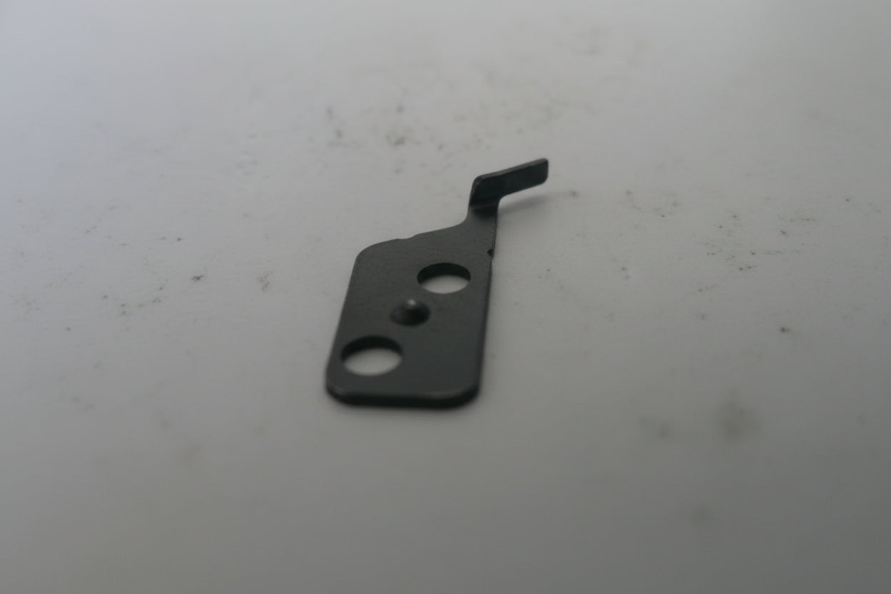 Small metallic object on a white background