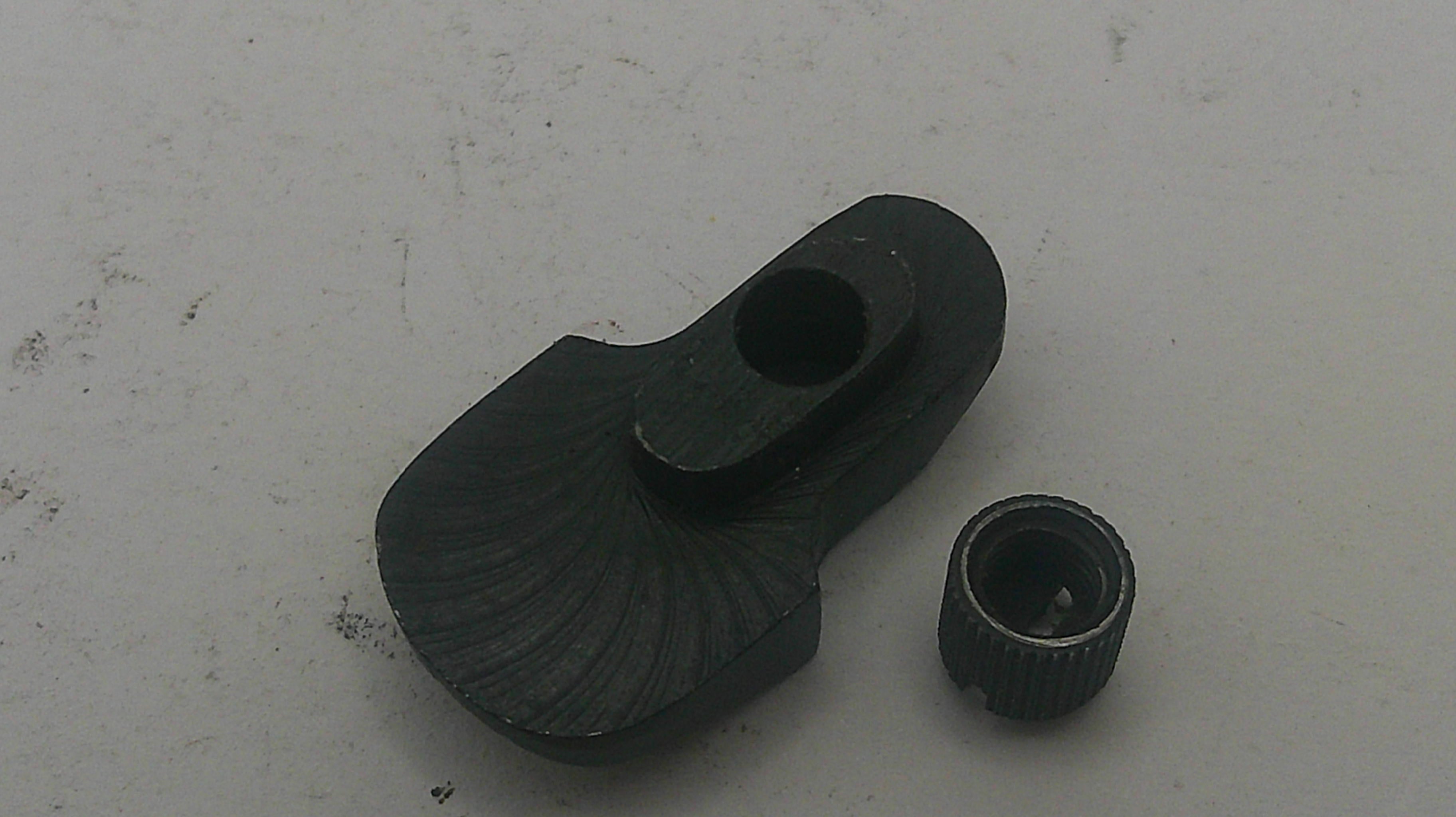 Black metal mechanical component on a white background