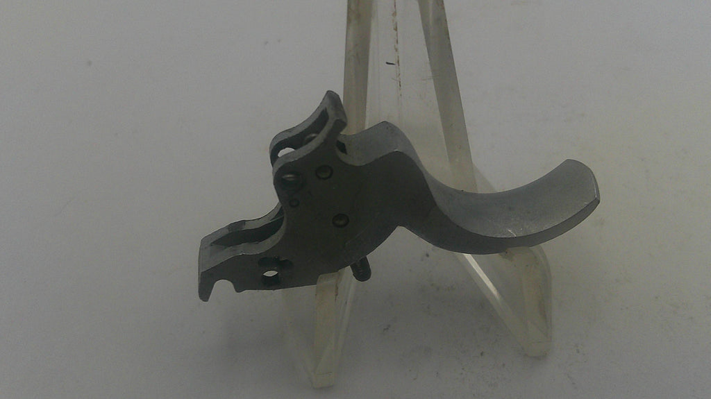 Metallic gun trigger on a white background