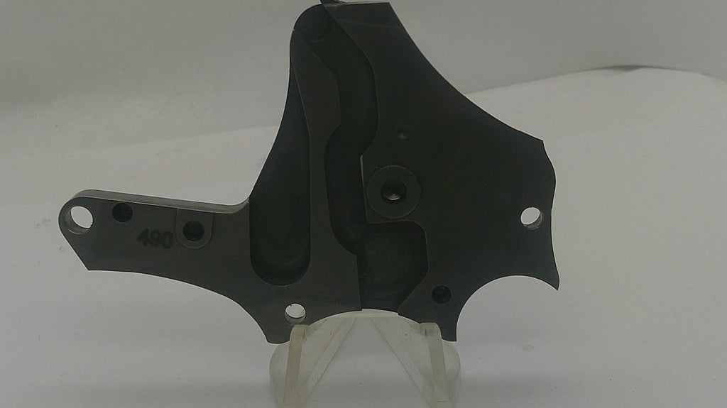 A black metal mechanical bracket or plate with pre-drilled mounting holes, displayed on a clear plastic stand against a white background.