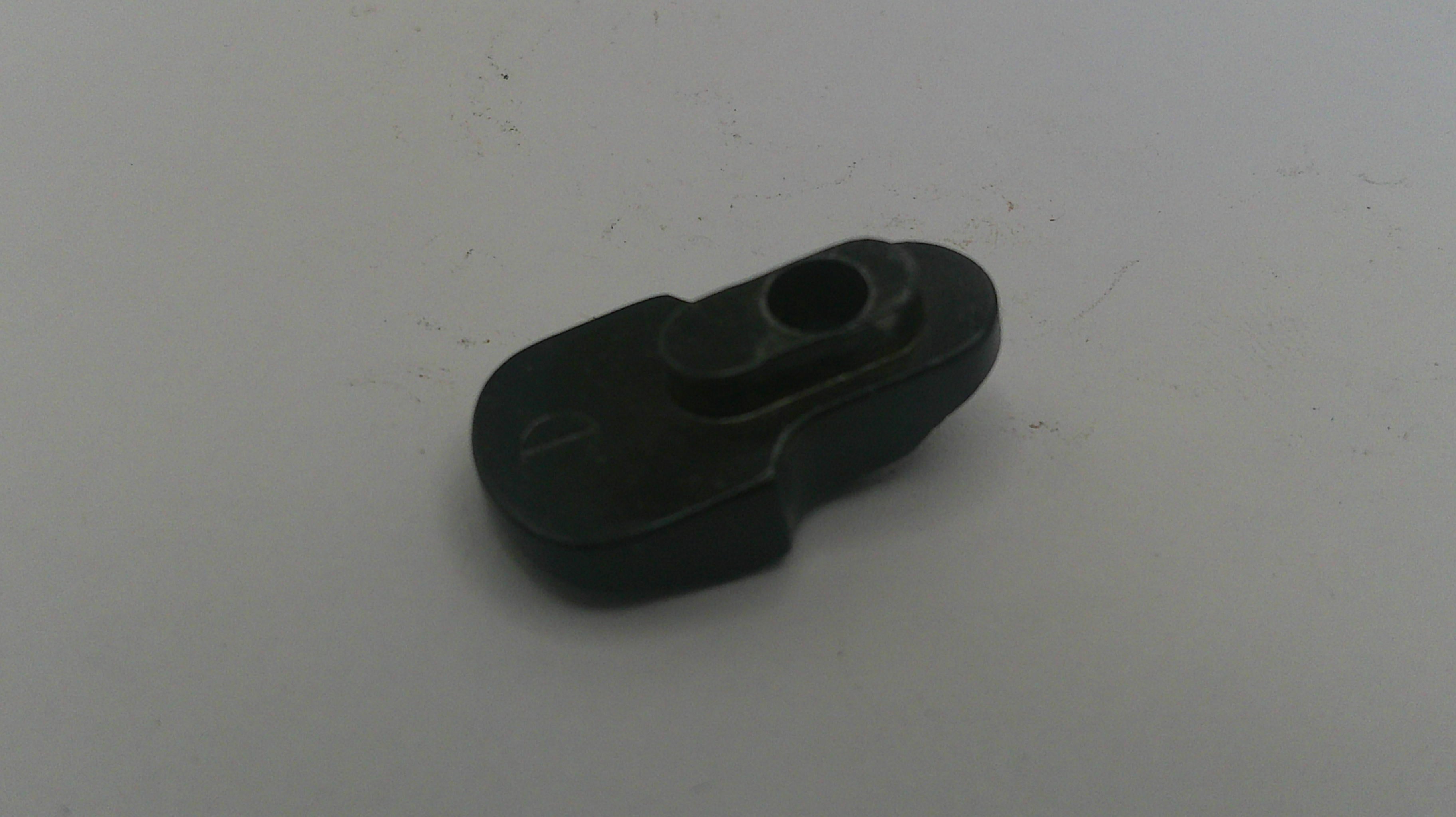 Black plastic component on a white background