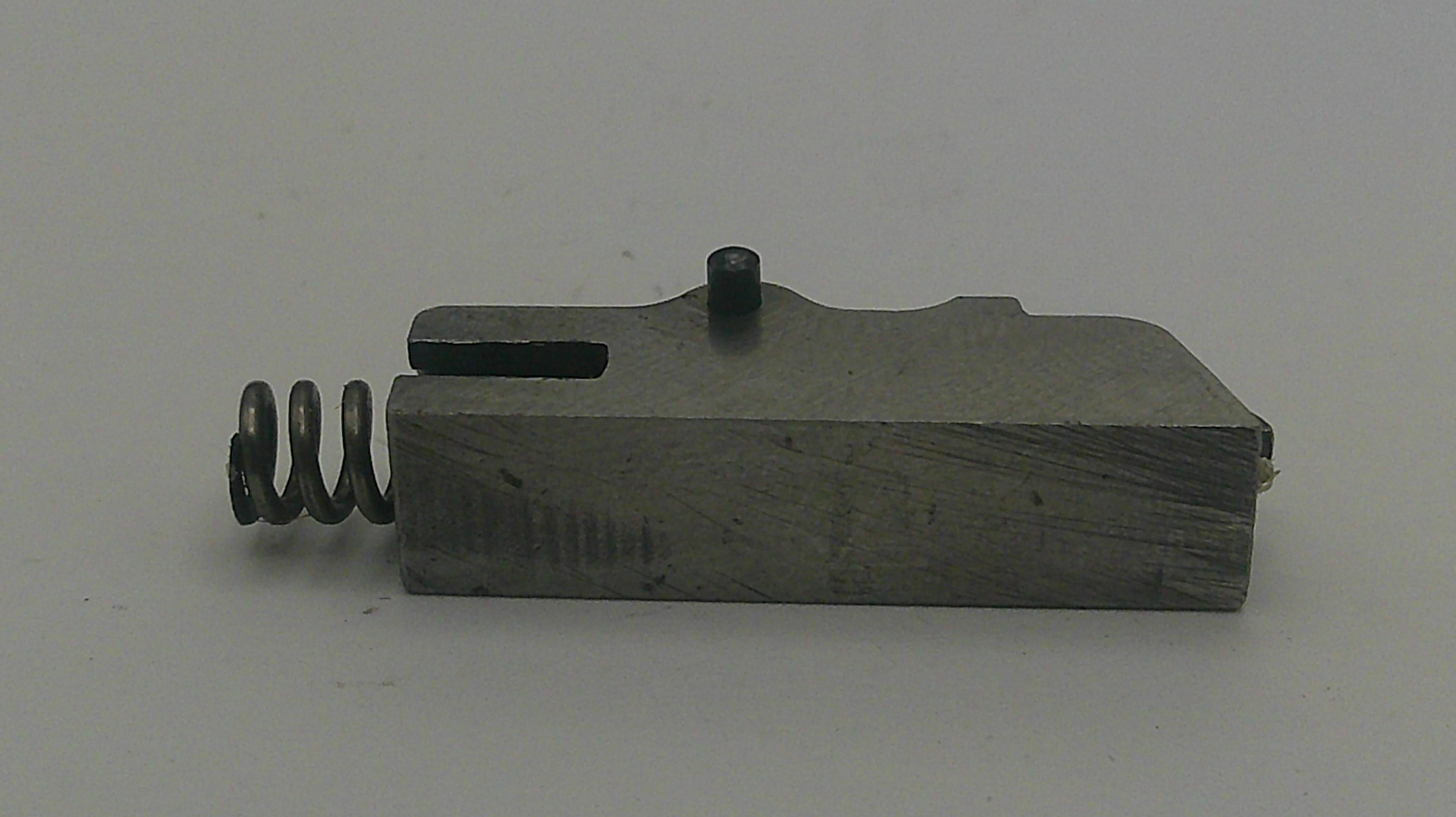 Mechanical component with a spring on a gray background