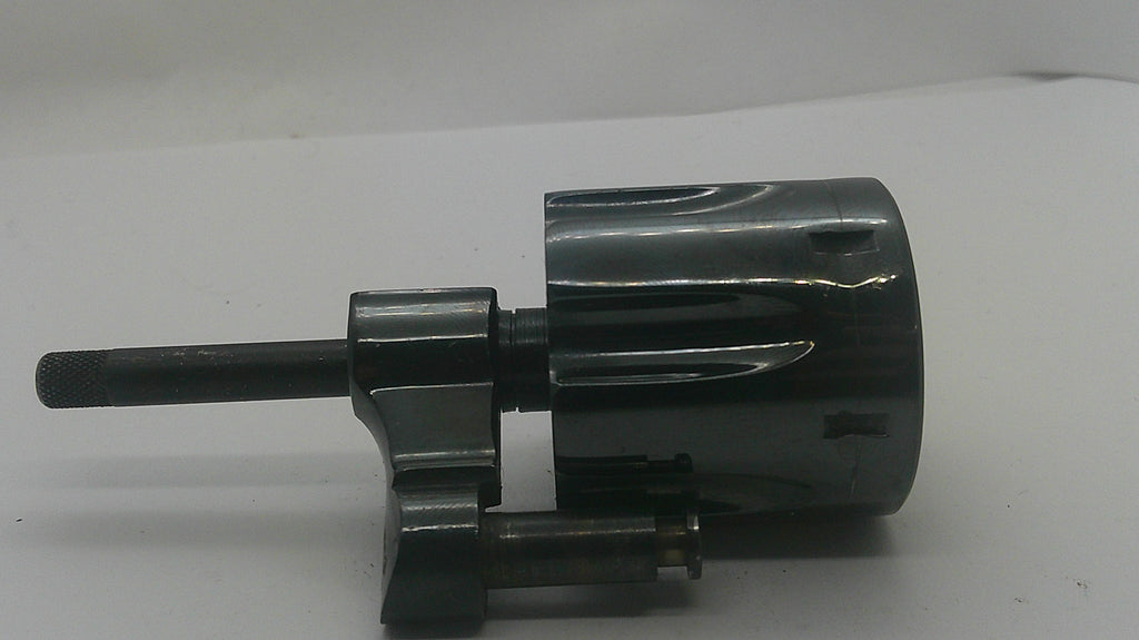 A black metal mechanical component with a cylindrical body, mounting bracket, and protruding shaft, photographed on a plain light background.