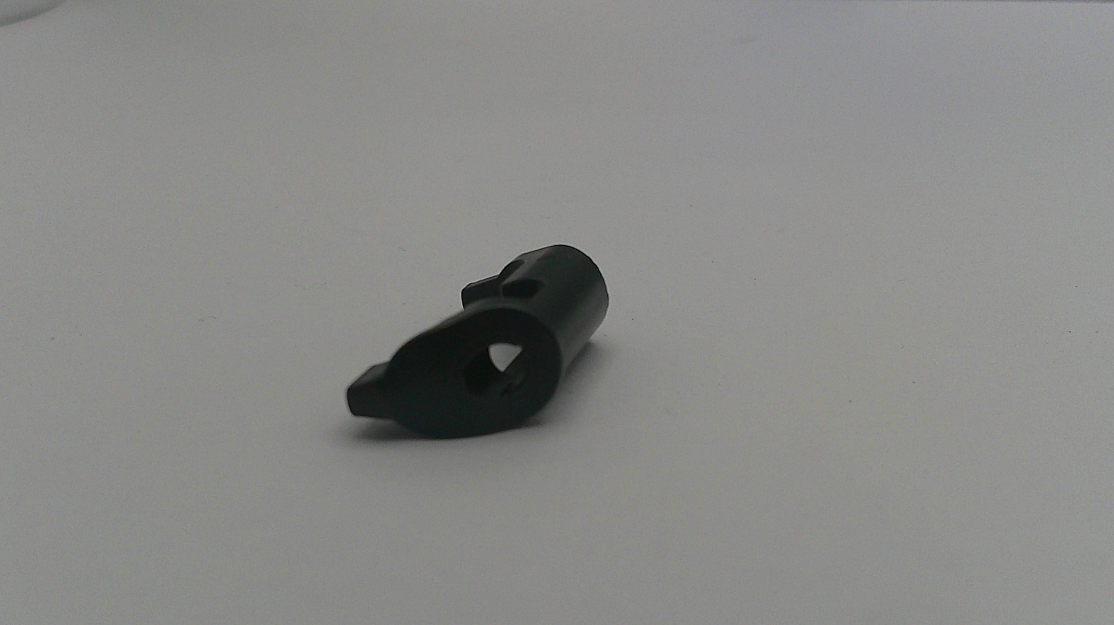 Black plastic component on a white background