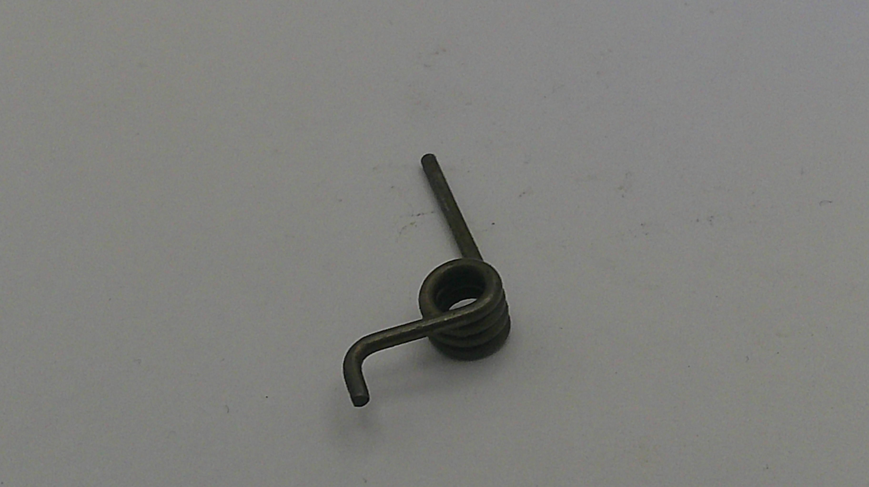 Small metal spring on a plain white background