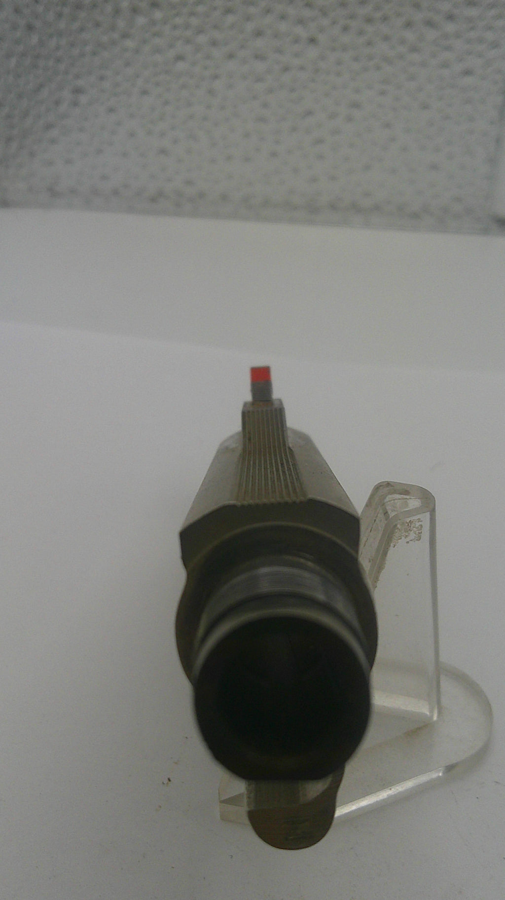 Black and red cylindrical object on a white background