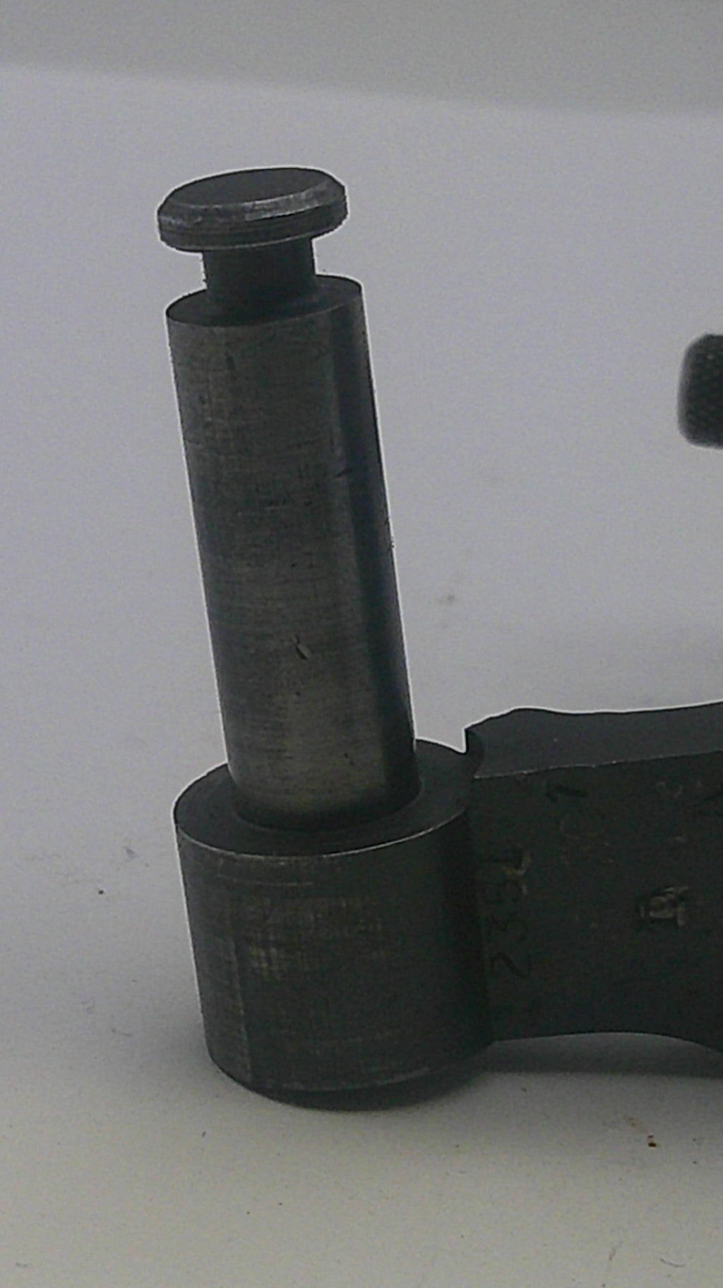 Close-up of a black metal component on a white background