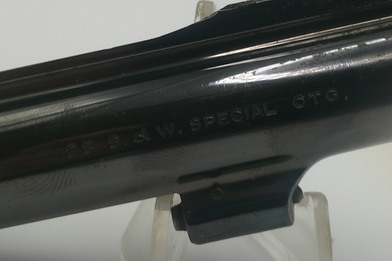Close-up of a black metal object with engraved text on a white background