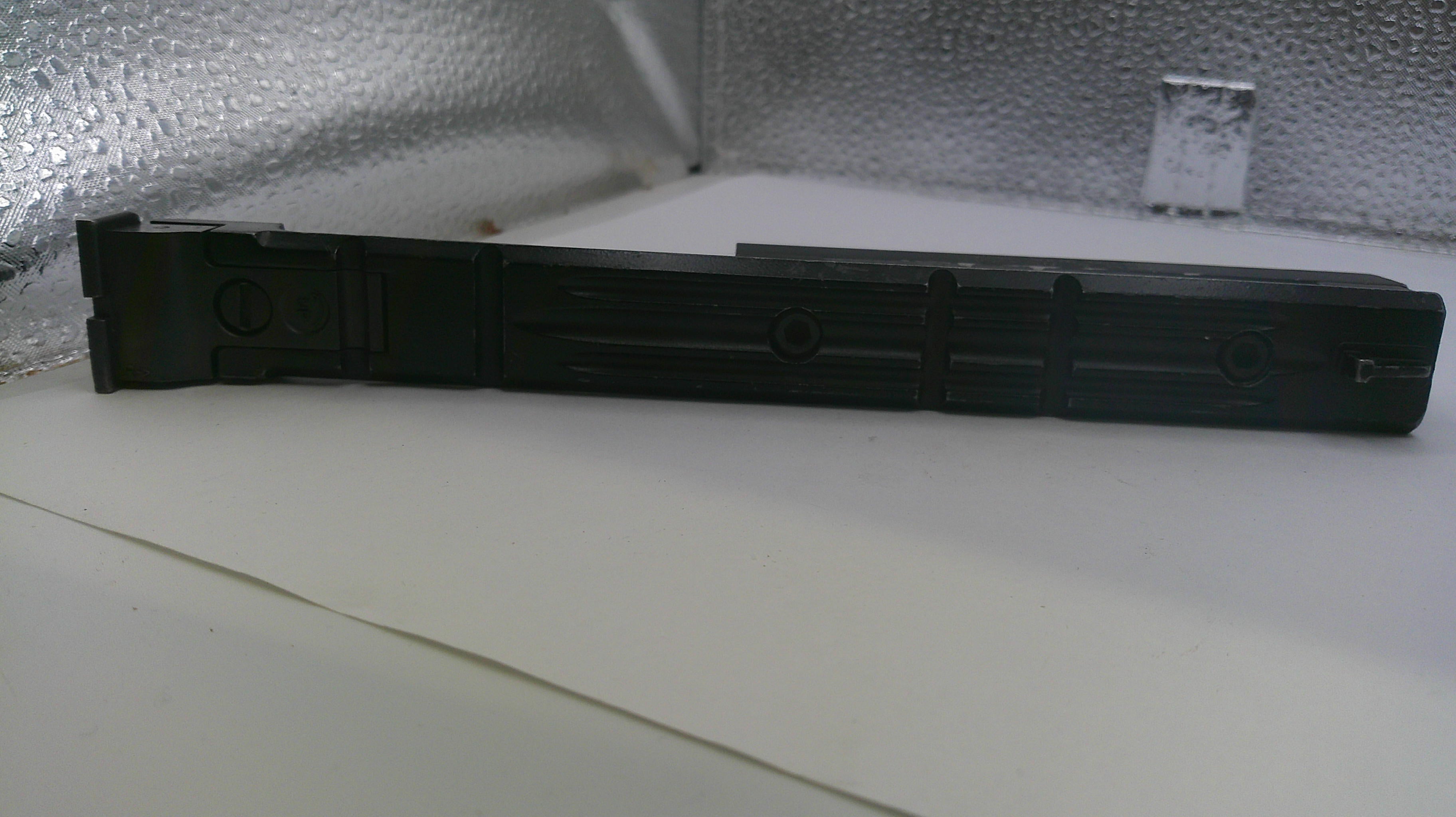 Black metal strip on a reflective surface