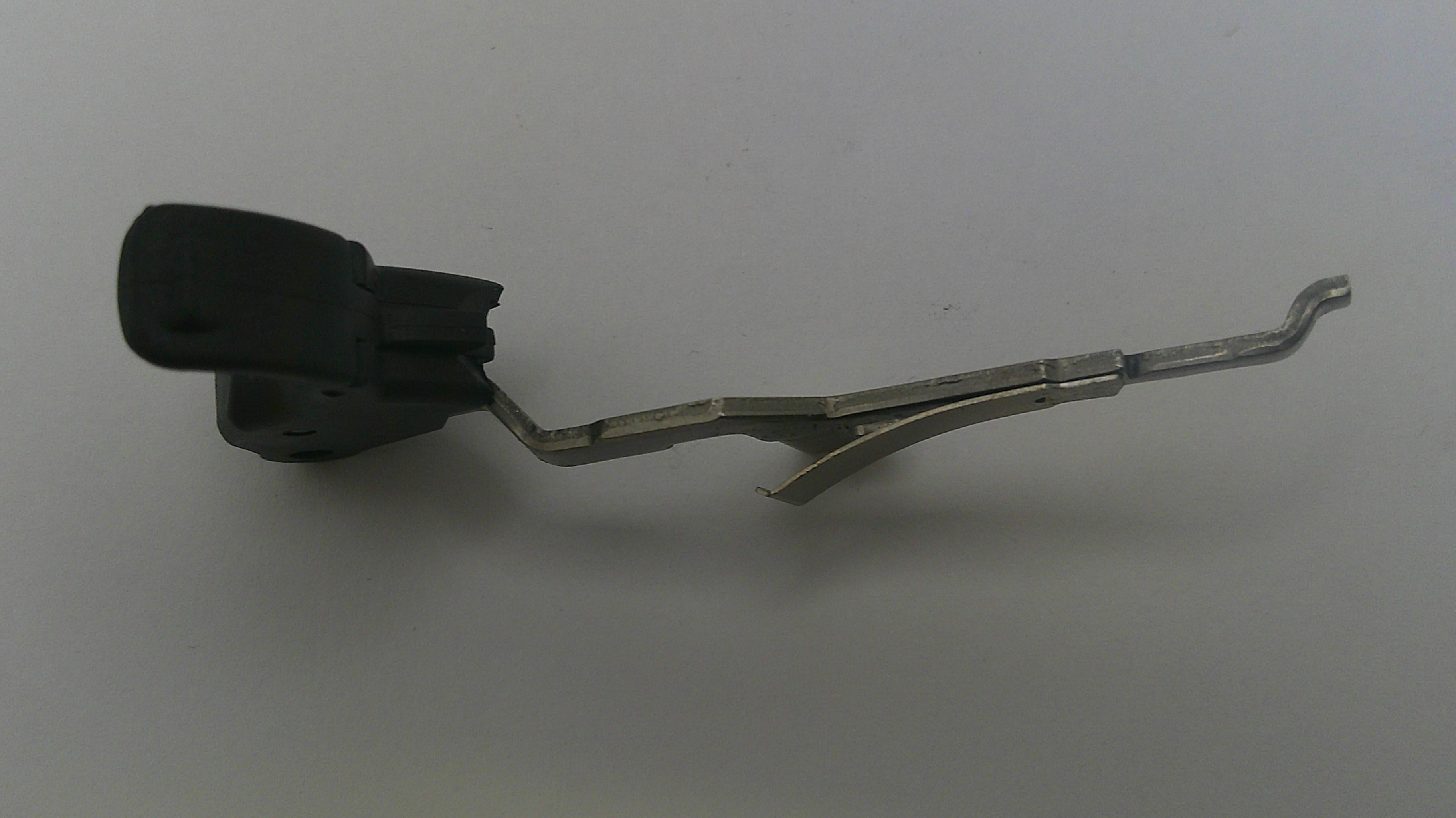 Metallic tool with a black handle on a white background