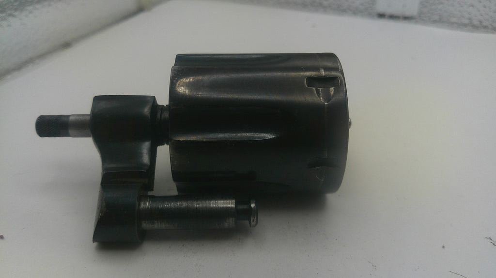 Black mechanical component on a white surface