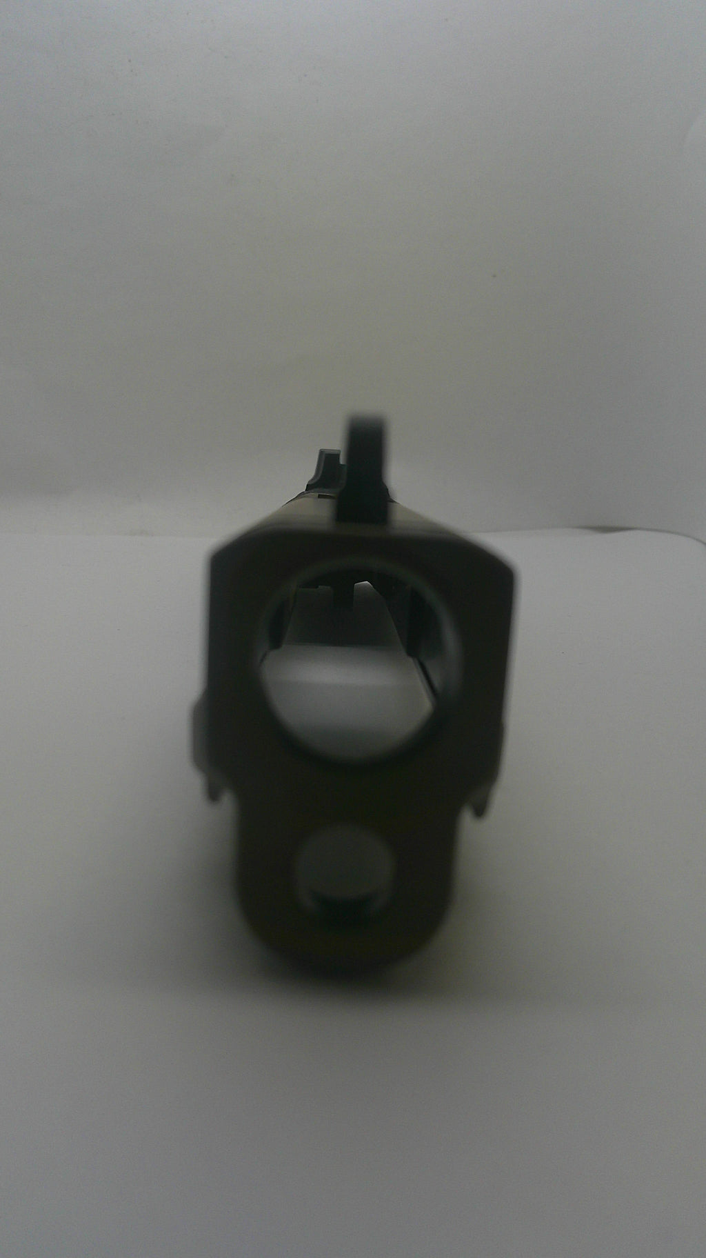 A dark metal mechanical component or hardware part with a circular opening, shown against a plain light gray background.