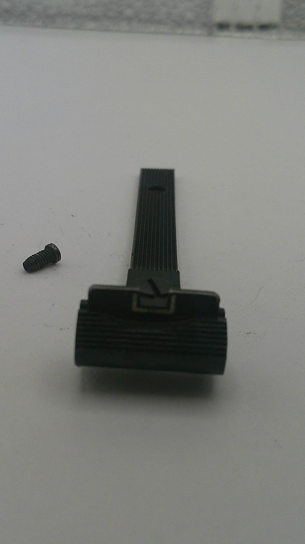 Black mechanical component on a white background