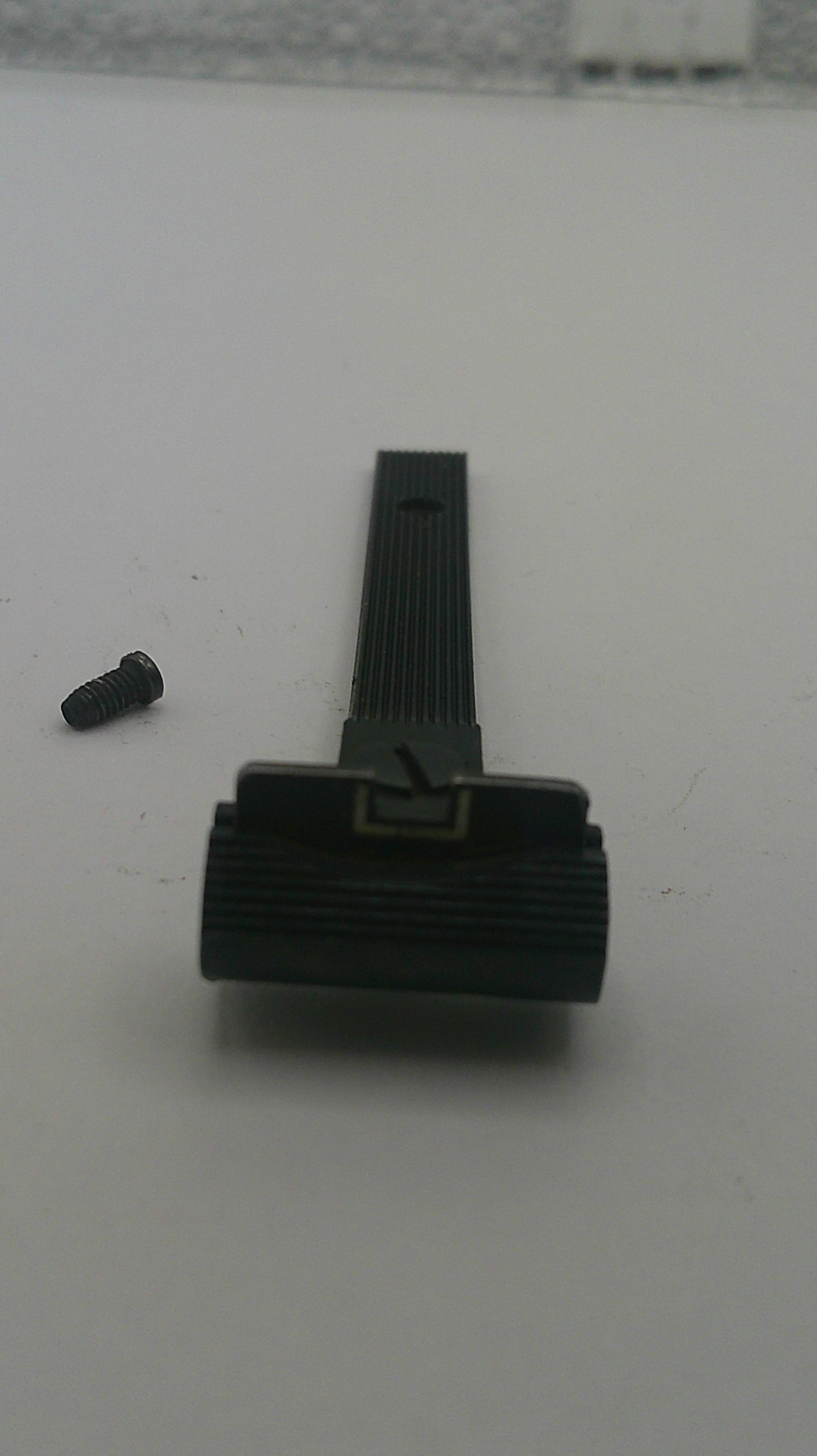 Black mechanical component on a white background
