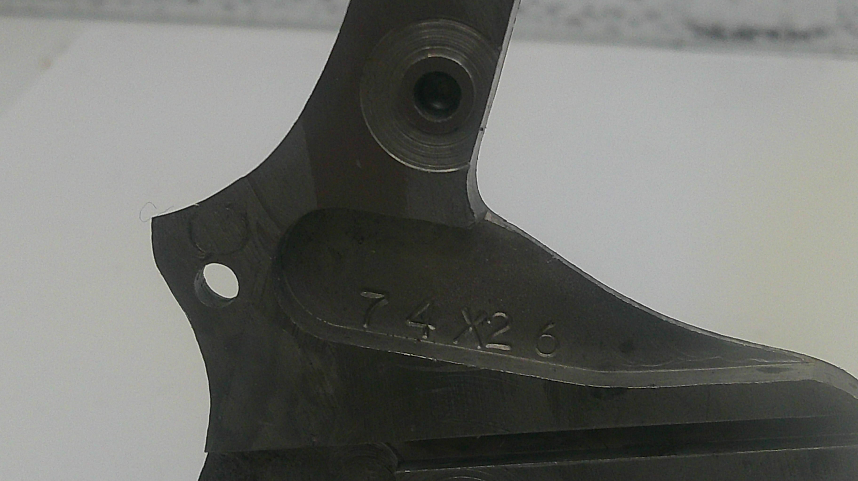 Black metal component with '7.4 x 26' marking on a white background