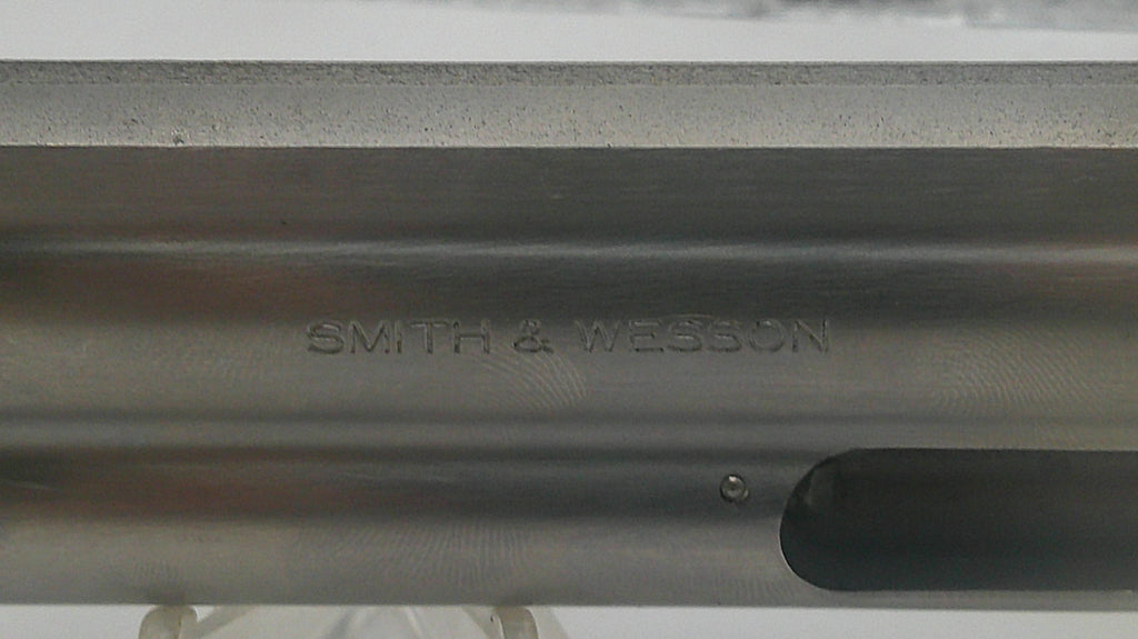 Close-up of a metallic object with 'Smith & Wesson' engraving.