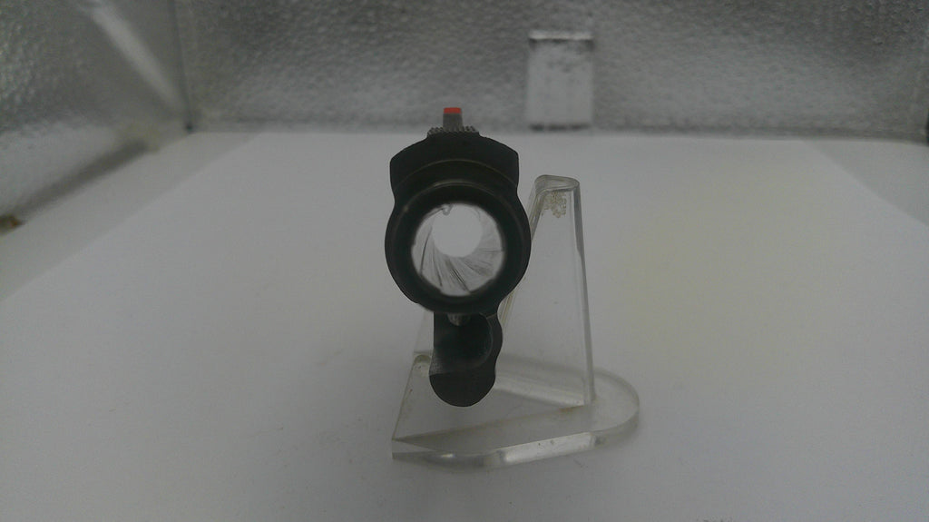 Black and white object on a clear stand against a neutral background