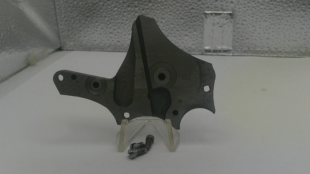Metal bracket with screws on a white surface