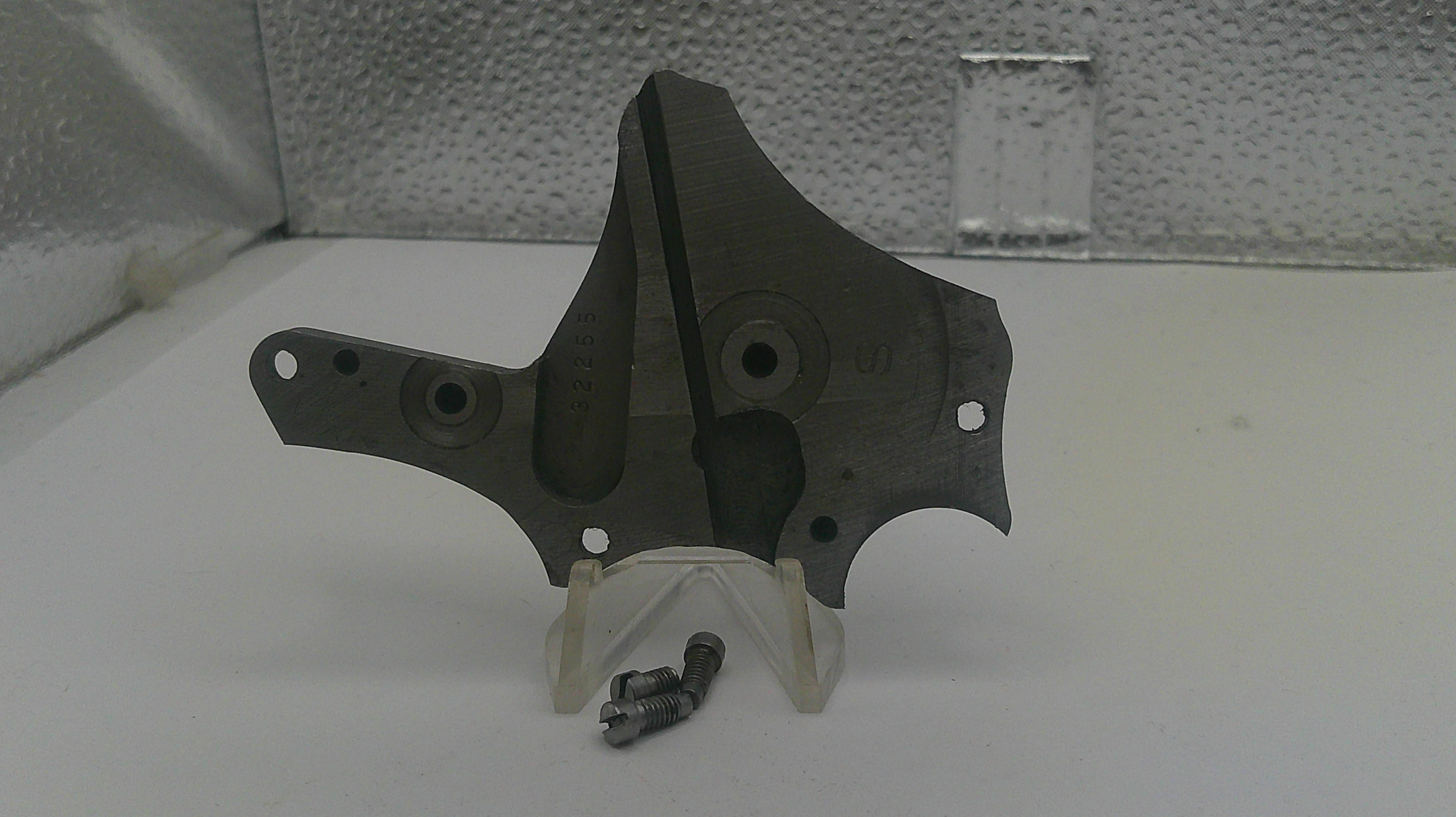 Metal bracket with screws on a white surface