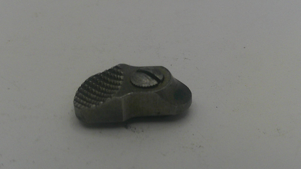 Small metallic object on a light gray background