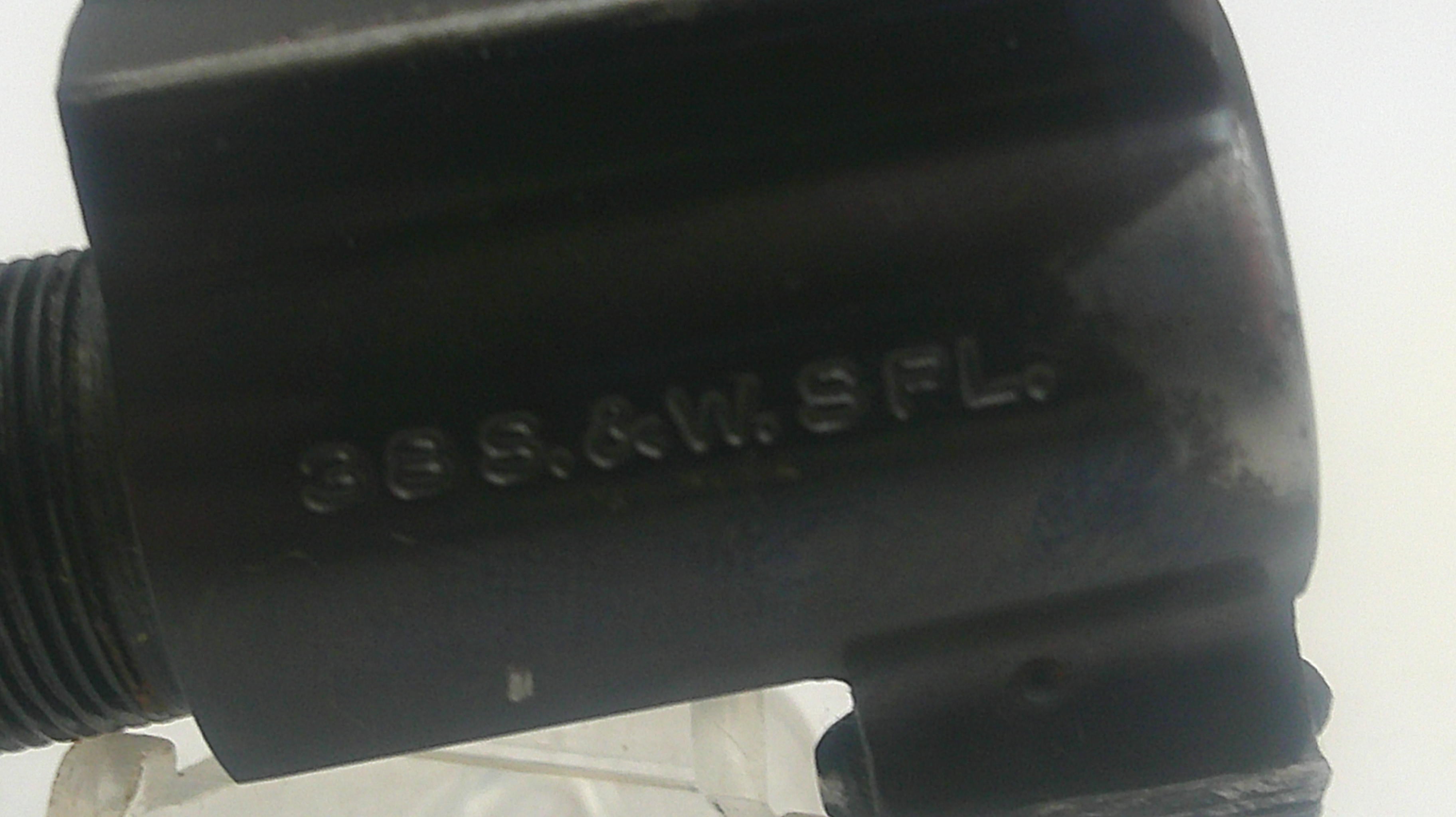 Black cylindrical object with text on a white background