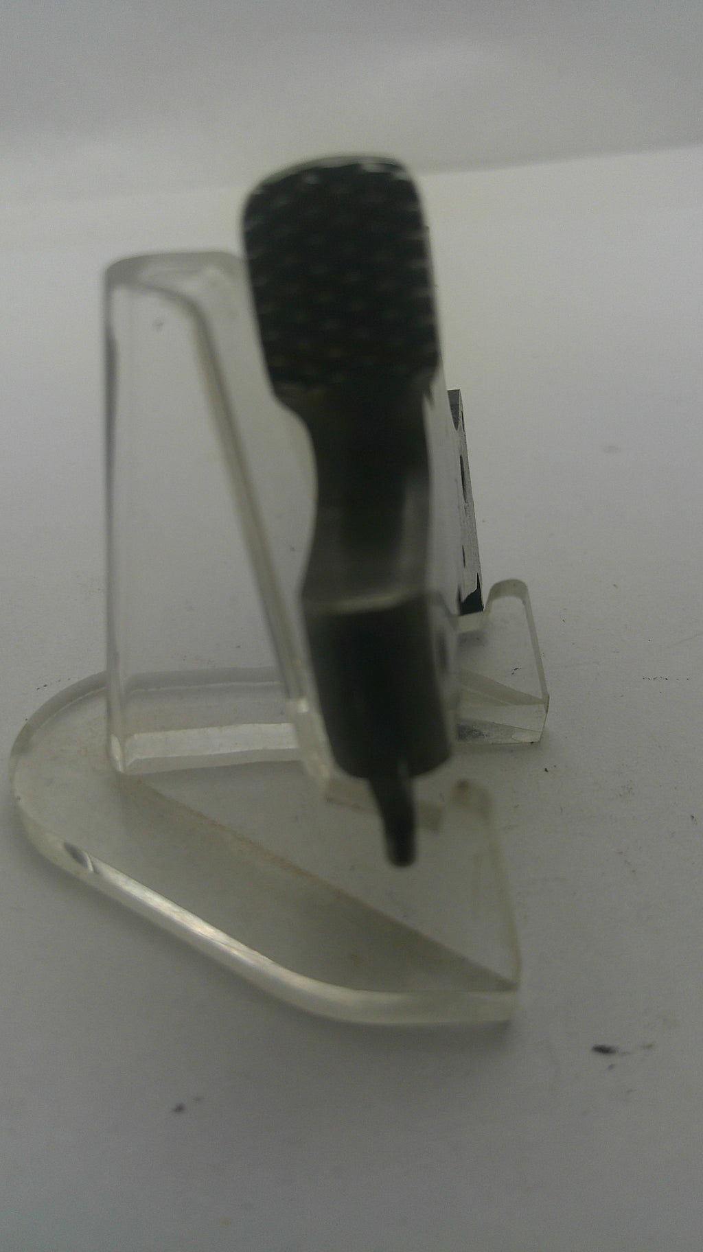 A clear plastic wall hook with a black textured hanging loop, shown against a plain white background.