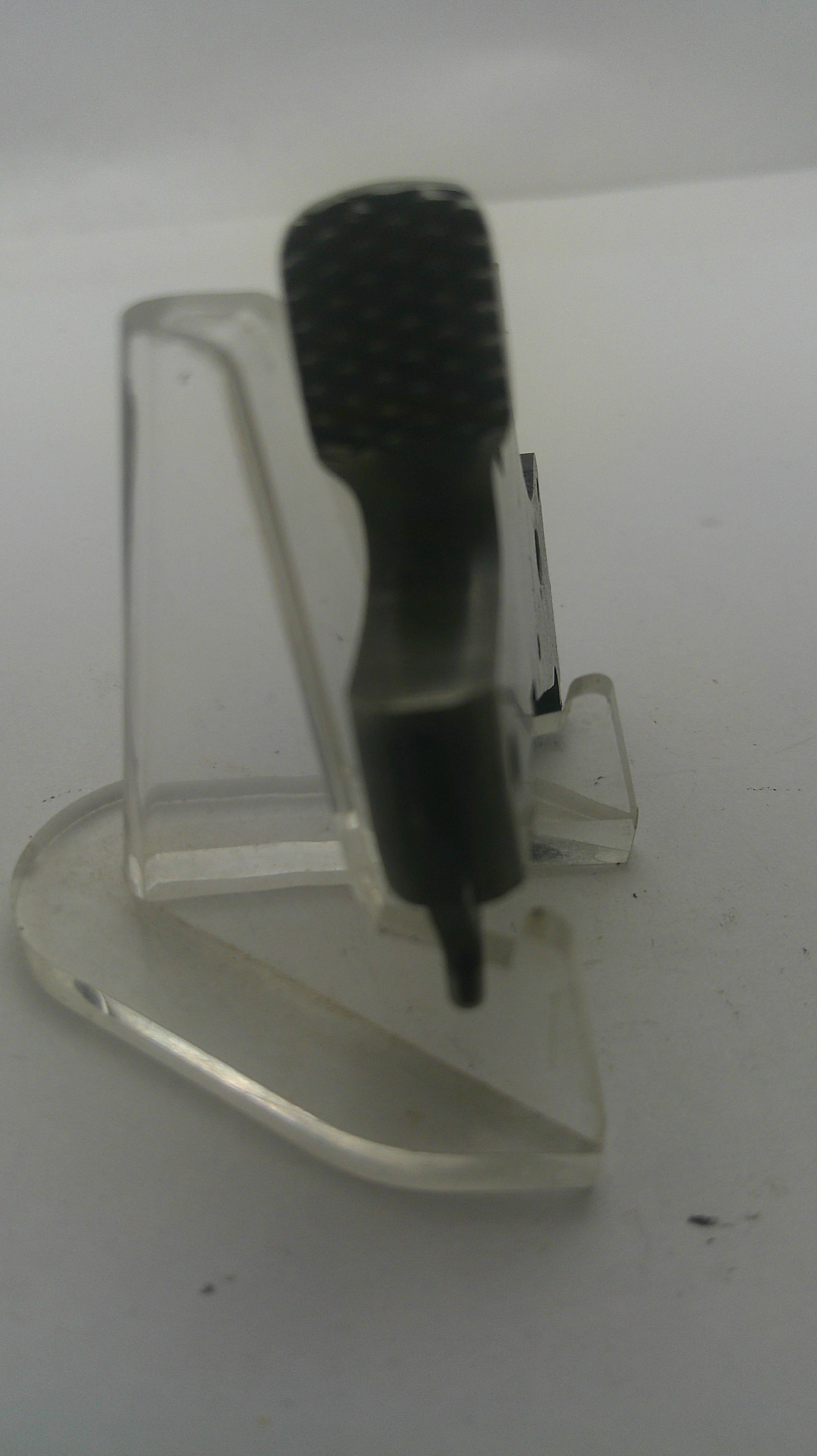 A clear plastic wall hook with a black textured hanging loop, shown against a plain white background.