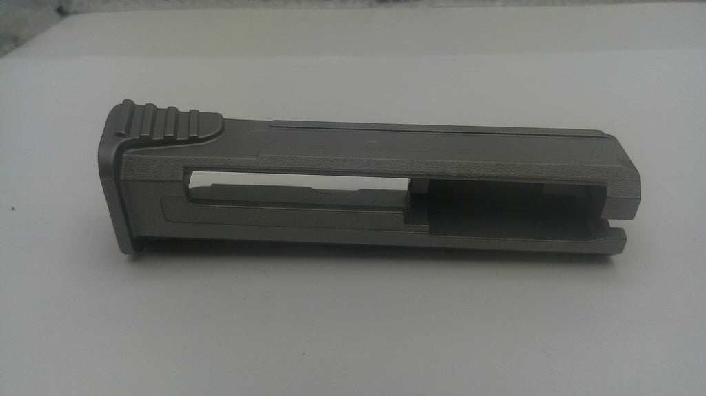 A dark gray plastic replacement part, likely a grip or handle component, shown on a plain white surface.
