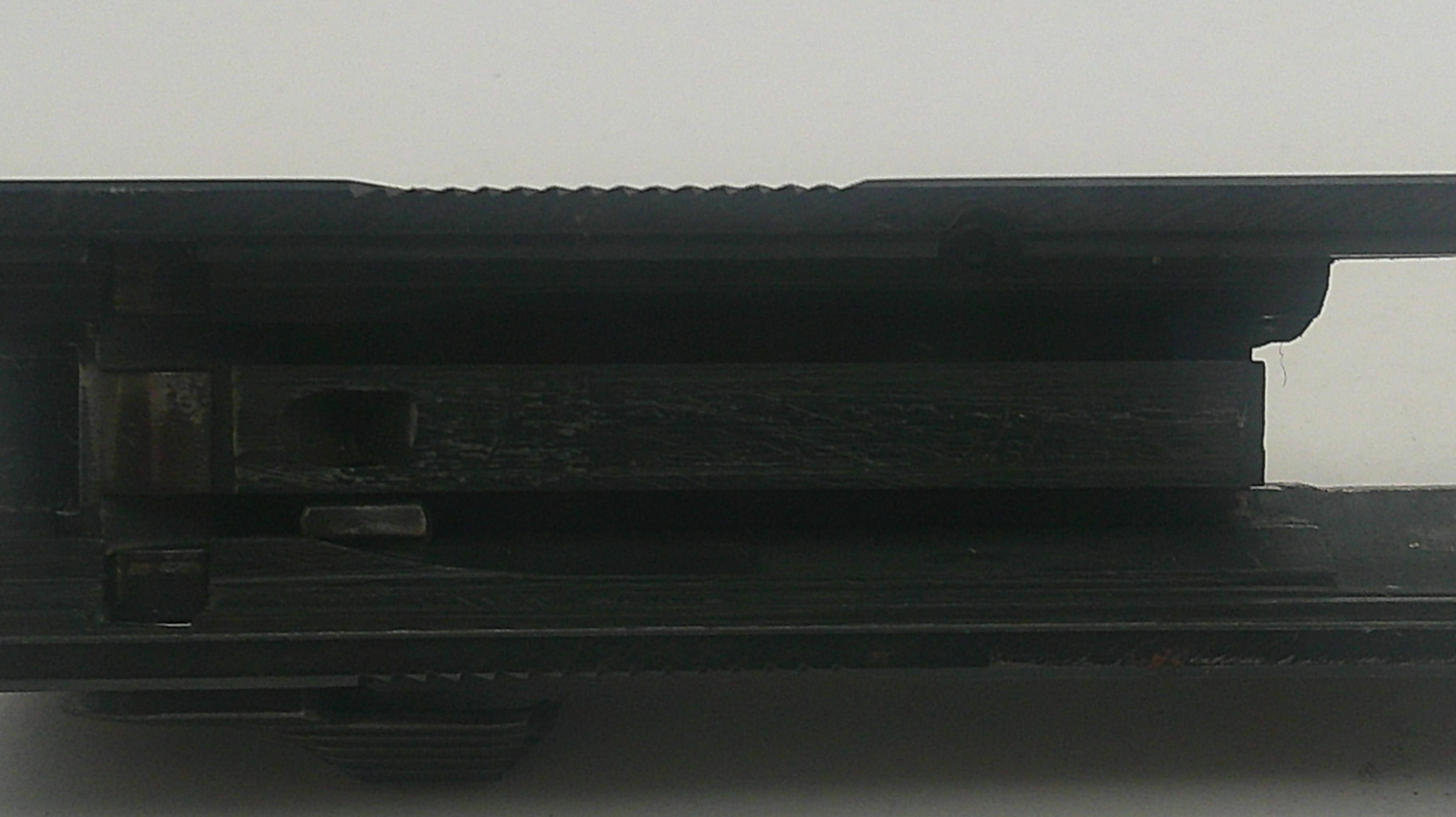 Close-up of a black electronic device with a white background