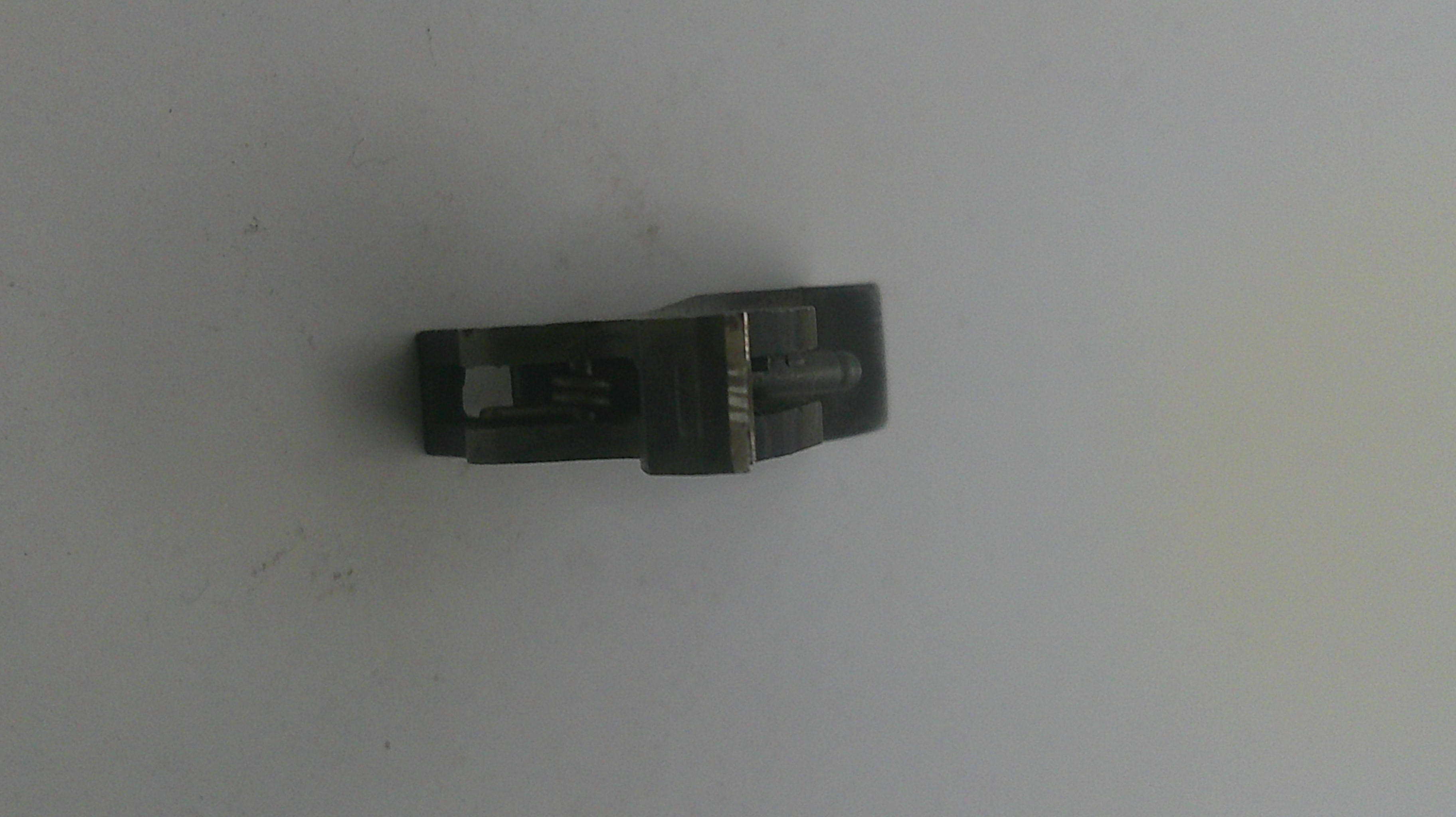 Metallic object on a light gray background