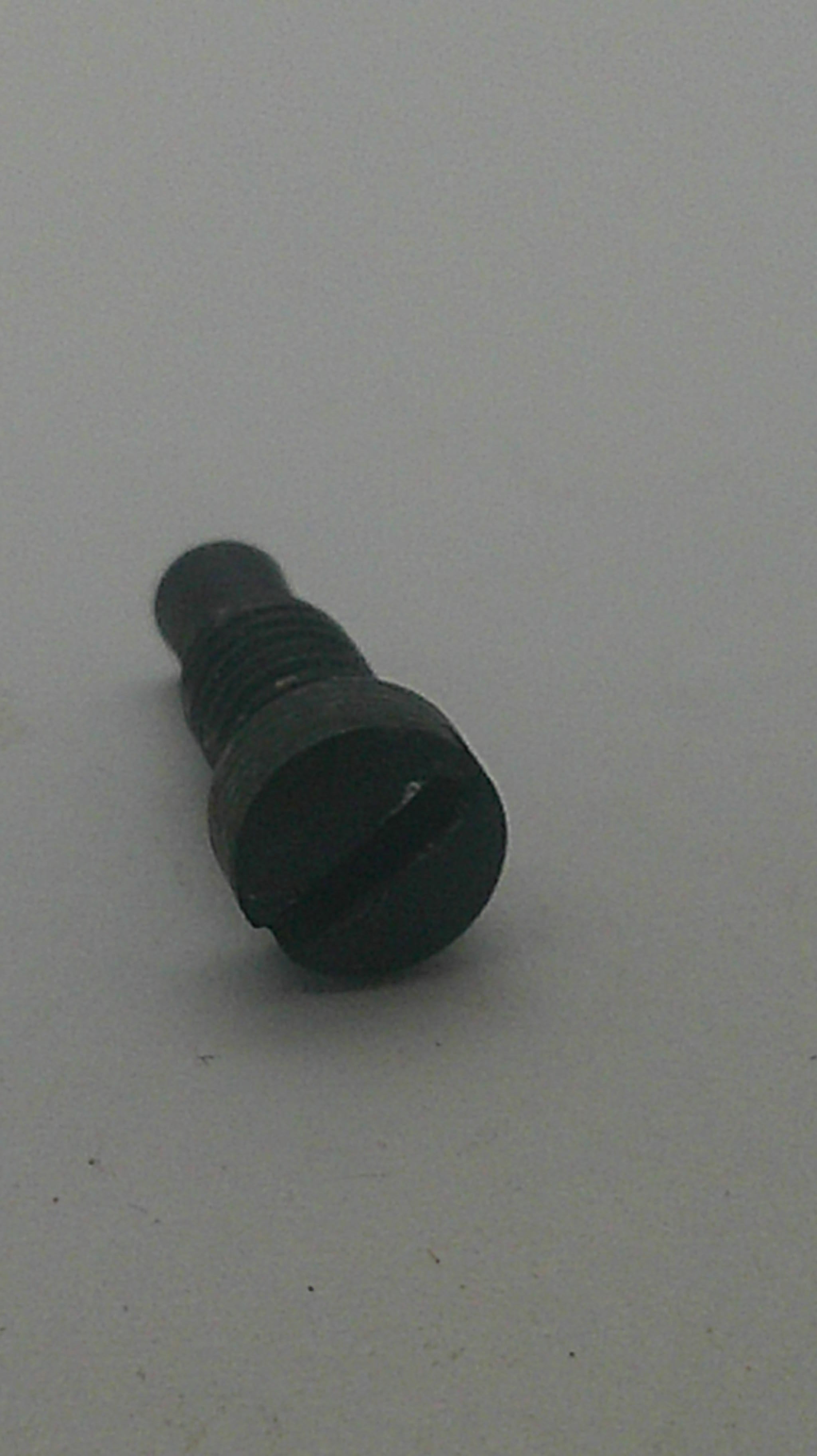 A small black plastic or rubber cylindrical component with a threaded end, photographed on a plain light gray background.