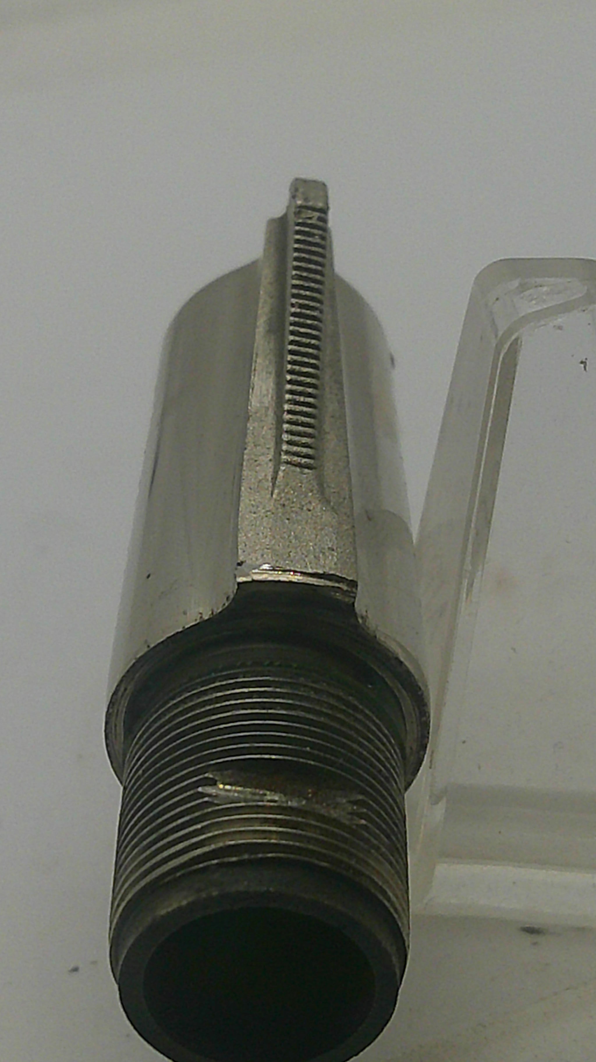 A metal threaded pipe fitting or connector with a hexagonal adjustment section, shown on a plain light background.