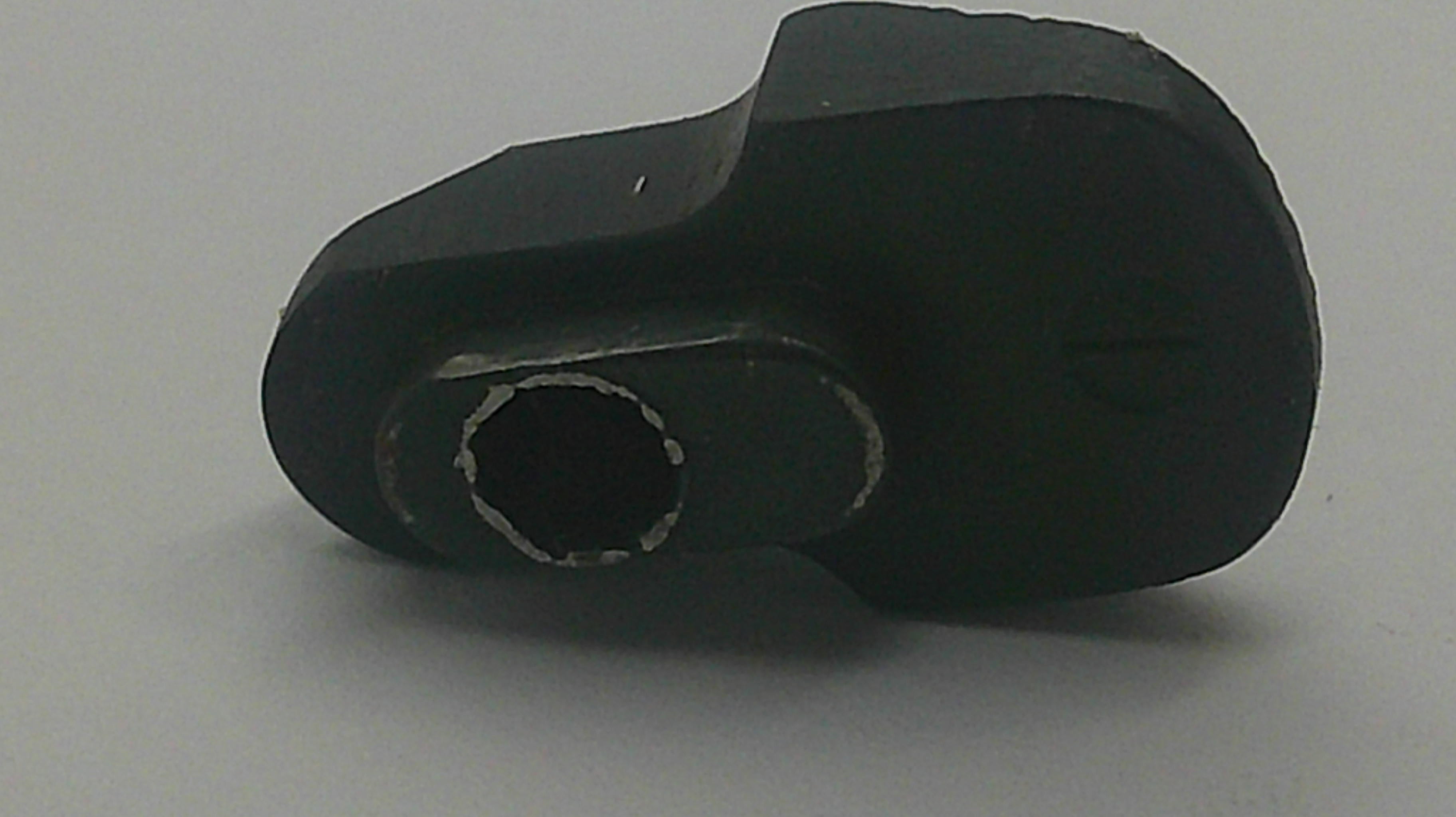 A black plastic mechanical component or adapter with a hexagonal opening, shown on a plain light gray background.