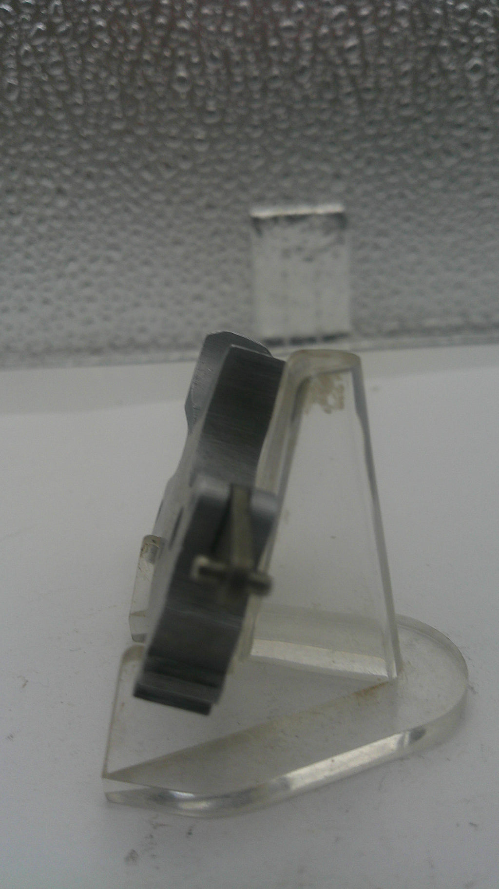 Metallic hook on a textured surface