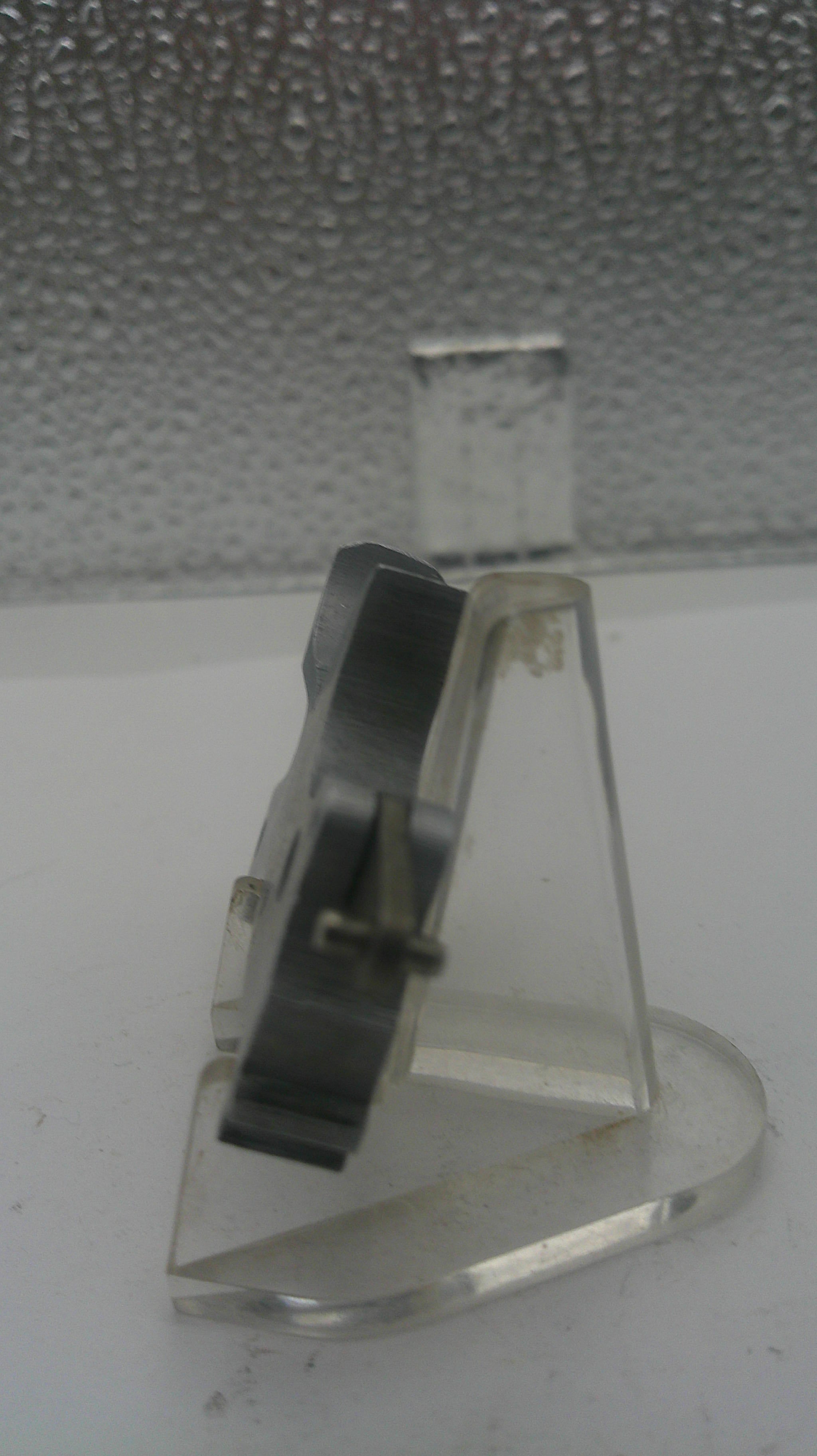 Metallic hook on a textured surface